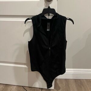 Black zip up body suit from GARAGE
